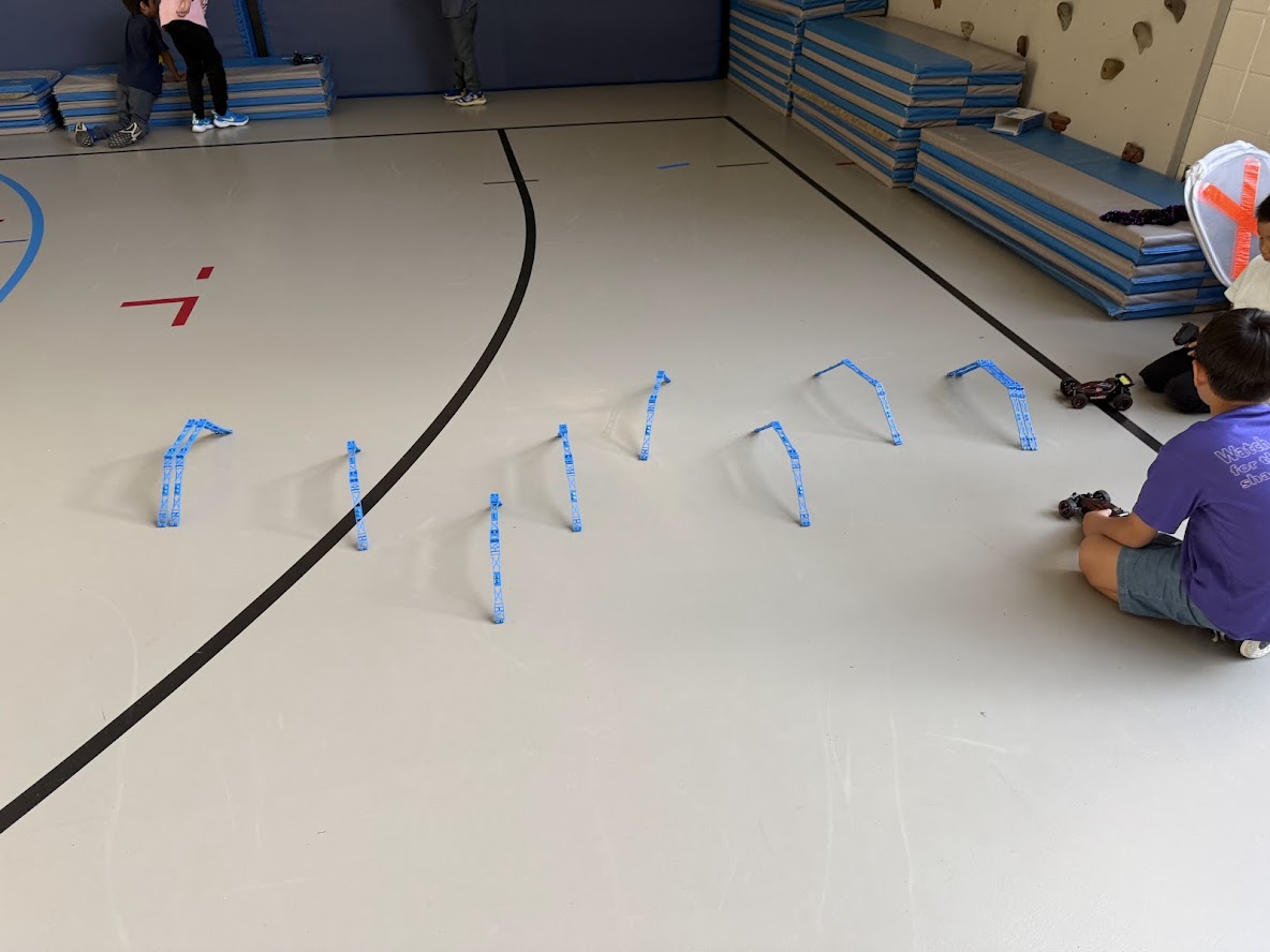RC car obstacle course set up in a gym